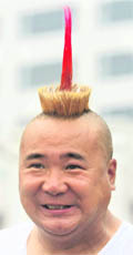 A street performer outside the Olympic Green sports an unusual hair style in Beijing on Thursday.