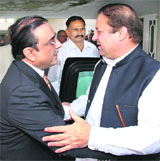 Asif Ali Zardari (left), co-chairman of the ruling Pakistan Peoples Party, greets Pakistans former Prime Minister Nawaz Sharif before a meeting in Islamabad 