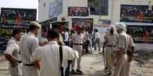 Policemen stand outside the Pukhraj cinema in Bathinda on Friday when the controversial film Singh is Kinng was screened.