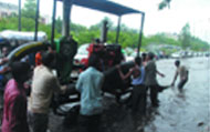 MCD workers try to drain water out of a road near Rajghat in New Delhi 