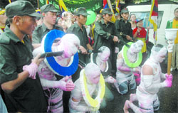Tibetan activists, on the inaugural day of the 2008 Beijing Olympics in China on Friday, perform a street play in New Delhi to denounce the alleged crackdown by Chinese soldiers on Tibetan protesters in Lhasa during a protest rally