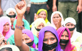Women protest with their mouths covered.