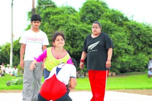 Two women wrestlers grappling in Chandgi Ram Akhara