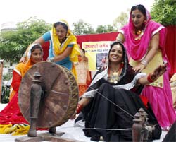 Women work at a spinning wheel at the Teej celebrations organised by the Phulkari Club at the Kamla Nehru Colony in Bathinda on Sunday.