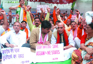 Bharatiya Janata Party president Rajnath Singh with the workers of the partys youth wing from North Eastern states, holds a dharna on the issue of infiltration of Bangladeshis, at Jantar Mantar in New Delhi on Sunday. 