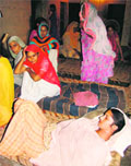 Sheetal lies on a cot after being rescued from a canal by residents of Gorgarh village near Karnal
