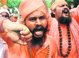 Sadhus raise slogans during a protest over the Amarnath land row in Delhi