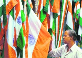 A customer looks for national flags at a shop in Siliguri