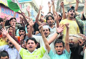 VHP activists shout anti-UPA government slogans during a demonstration against the revocation of the transfer of land to the Amarnath Shrine Board in New Delhi