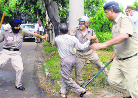 Policemen try to nab a protester during a clash on the road dividing Sectors 7 and 8 in Chandigarh on Monday.
