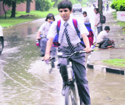 Schoolchildren face tough time paddling their bicycles after the rainfall in Ludhiana