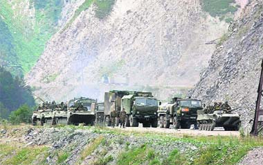 Russian troops move along a road near the border between North and South Ossetia on Monday. Moscow insisted it had not moved its troops beyond the territory of South Ossetia and the second separatist region, Abkhazia. 