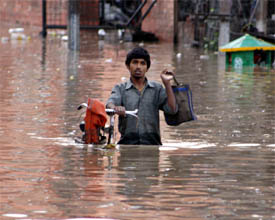 A cyclist makes his way through waist-deep water that accumulated in the Sirki Bazaar area of Bathinda following a brief but heavy rainfall on Tuesday.