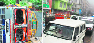A view of the truck that overturned near Khalini in Shimla on Tuesday; and (right) the resultant traffic jam on the road.