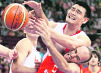 Yao Ming of China (top) and Carlos Jimenez of Spain battle for a rebound during a Group B mens basketball game