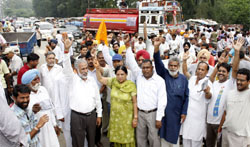 VHP and BJP activists block traffic in Bathinda on Wednesday during the chakka jam called to protest against the cancellation of land allotted to the Amarnath Shrine Board by the J&K government