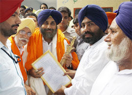 SAD chief Sukhbir Badal being presented a charter of demands by the leaders of the village Gyana near Talwandi Sabo