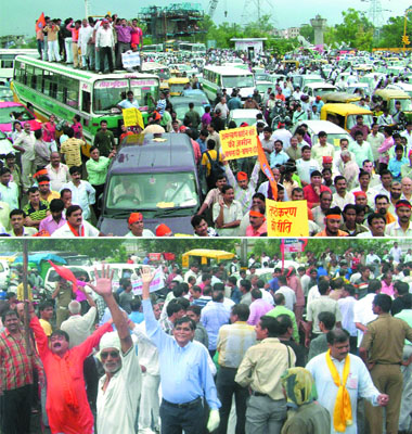 Activists of the Bharatiya Janata Party and the Vishwa Hindu Parishad protest at Shakarpur and Burari (down) crossing during the 'chakka jam' over the Amarnath land row, in New Delhi on Wednesday.