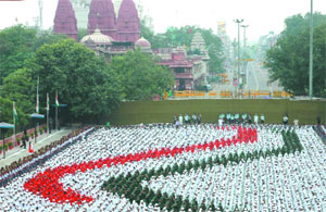 Children dressed in tricolour rehearse for the Independence Day celebrtions