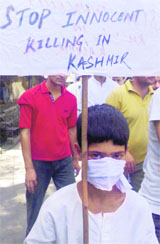 A child carries a placard, which reads stop innocent killing in Kashmir, in Rajouri on Wednesday.