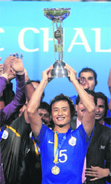 Indias captain Bhaichung Bhutia (C) holds the trophy after winning the final of the AFC Challenge Cup against Tajikistan in New Delhi on Wednesday.