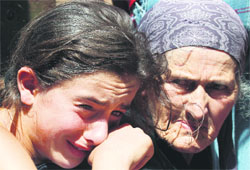 People react as they leave Gori, a Georgian town near South Ossetia, on Wednesday.