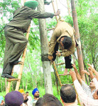  Employees of the electricity department bring down the body of lineman Sandeepan Kumar, who was electrocuted in Chandigarh on Thursday.