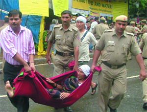 A Tibetan activist being carried by Delhi police personnel while she was protesting against China at Jantar Mantar in New Delhi on Thursday.