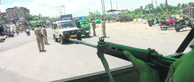 Security personnel check vehicles on the eve of Independence Day in Jammu