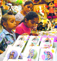  Children select rakhis at a shop in Model Town in Jalandhar on Thursday.