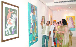 Art lovers appreciate a painting at Vibes of Spirits exhibition in Jalandhar. 