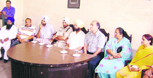 Councillor Ravinder Puri addresses a gathering after MC president Usha Rani Sood (right) took charge of the office at Ahmedgarh. 