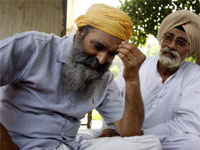 Rajinder Singh Saini, the worried father of Parminder, being consoled by an acquaintance at his residence in Bathinda on Friday.