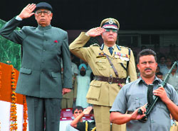 Governor N.N. Vohra takes the salute during the 62nd Independence Day celebrations at Bakshi Stadium in Srinagar on Friday; and (right) a policeman shows his daredevil act on the occasion.