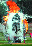 Governor N.N. Vohra takes the salute during the 62nd Independence Day celebrations at Bakshi Stadium in Srinagar on Friday; and (right) a policeman shows his daredevil act on the occasion.