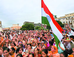 Supporters of the Shri Amarnath Yatra Sangharsh Samiti hold the National Flag during the Independence Day celebrations in Jammu on Friday.