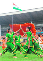 Schoolgirls present a folk dance during the I-Day function at Guru Nanak Stadium