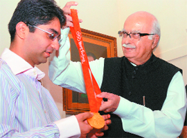 Leader of Opposition in the Lok Sabha L.K Advani congratulates Olympic gold medallist Abhinav Bindra in New Delhi on Friday.