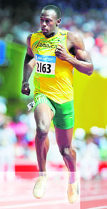 Usain Bolt of Jamaica competes in the mens 100m heat at the National Stadium on Friday. 