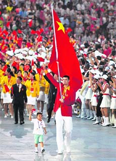 Chinas flag bearer Yao Ming and Lin Hao, a nine-year-old survivor of the earthquake, lead the Chinese athletes during the opening ceremony