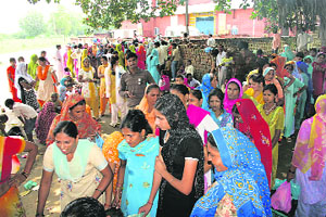 Women await their turn to make an entry in the visitors register outside the jail in Rohtak on Raksha Bandhan on Saturday.