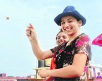 A girl flies a kite on the occasion of Raksha Bandhan in Jammu on Saturday. 