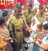 State health minister Laxmi Kanta Chawla ties rakhi on the hands of BSF jawans at the Attari-Wagah joint check-post near Amritsar on Saturday.