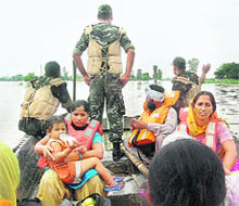 Army personnel rescue the marooned persons to safer places near Gidder Pindi village, on Saturday.