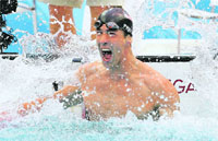 Michael Phelps of the U.S. celebrates after winning the men's 100m butterfly swimming final at the National Aquatics Centre during the Beijing 2008 Olympic Games 