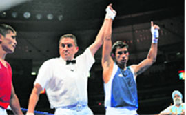Indias Jitender Kumar (R) is declared winner after defeating Uzbekistans Tulashboy Doniyorov during their 2008 Olympic Games Flyweight (51 kg) boxing bout on Saturday in Beijing
