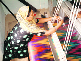 Afsana, a weaver, and others of her community struggle to make ends meet because of the dip in demand for saris 