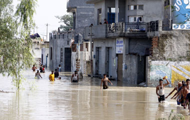 Residents of a flood-hit village in Ferozepur wade through the waters to a safer place on Sunday.