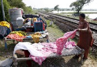 A family puts up near railway track after their house was marooned in flood waters in village Chakian in the Ferozepur district on Sunday.
