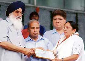 Social worker Amarjit Kaur Dhillon being honoured by Punjab Chief Minister Parkash Singh Badal at a state-level function in Ludhiana